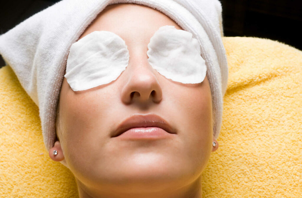 A young woman lying down with an eye mask on both eyes to relieve dry eyes.