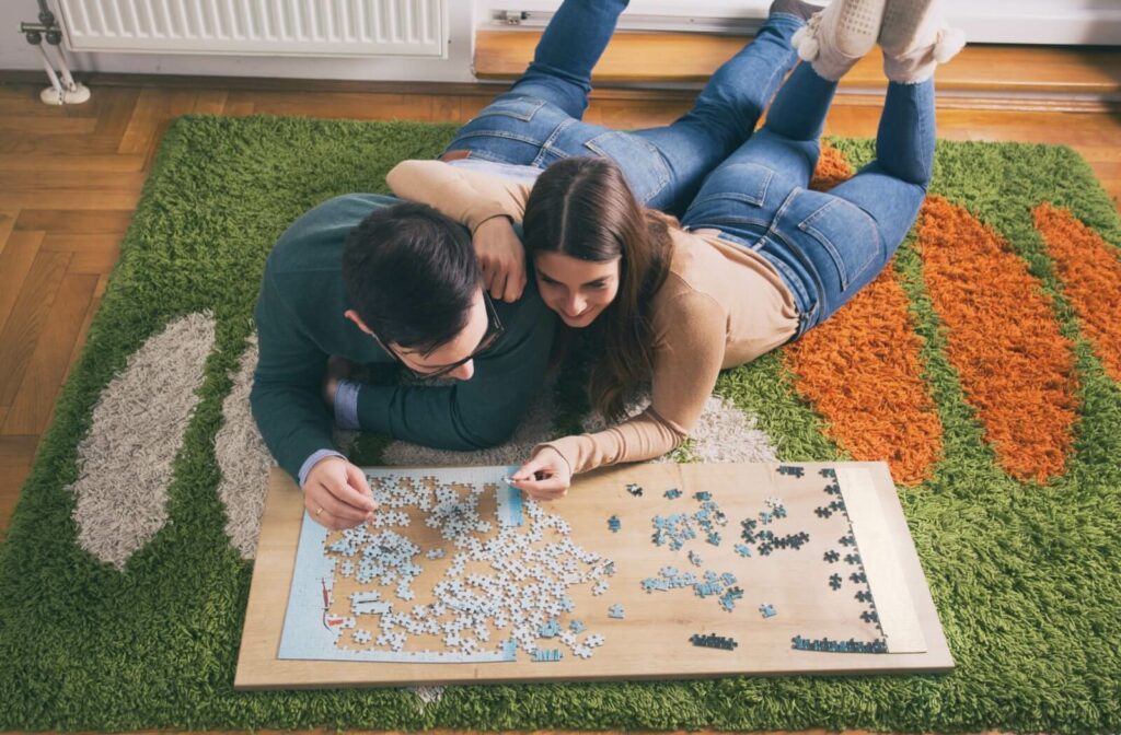 A young couple solving a jigsaw puzzle together to enhance their visual perceptual skills.