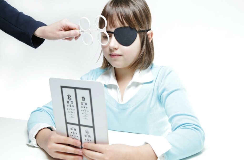 A child wearing an eye patch does a vision therapy exercise with the other eye.
