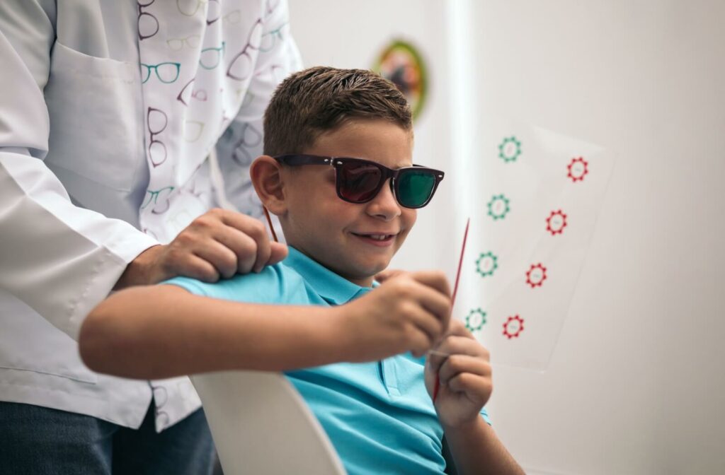 A child completes a vision therapy exercise under the guidance of their eye doctor.